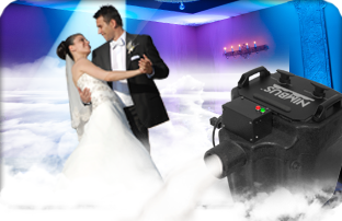 A bride and groom operating a dj machine with equipment.