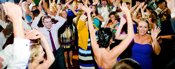 A group of people dancing at a wedding, having the perfect time.